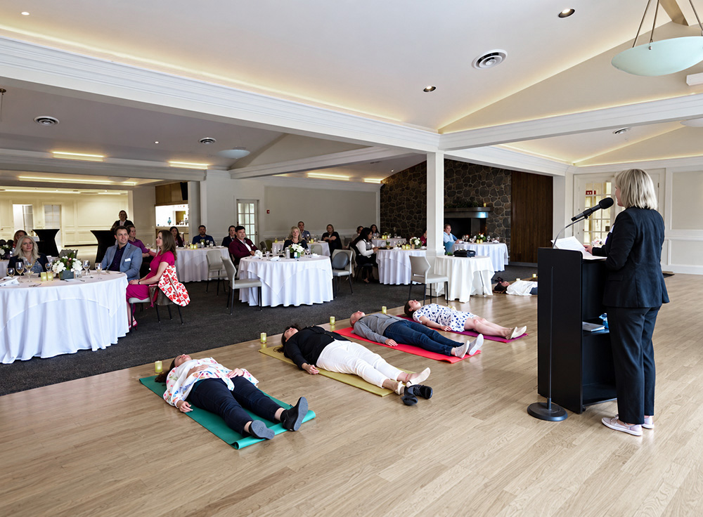 Workshop participants seated in a circle on the floor